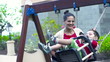 Video: Happy family. Mother pushing son on swing, slow motion shot at 2 Happy family. Mother pushing son on swing, slow motion shot at 2