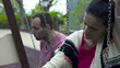 Sad couple sitting on a swing, slow motion shot at 240fps 