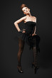 Foto: Rock female with guitar over dark background. Rock female with guitar over dark background.