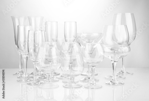 Photo: Cocktail and wine glasses, on gray background Cocktail and wine glasses, on gray background