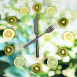 Clock made of kiwi, lime and lemon slices, on bright background