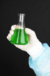 Glass tube with fluid in scientist hand during medical test