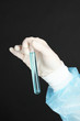 Glass tube with fluid in scientist hand during medical test