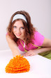 Young housewife cleaning up table at home on grey background