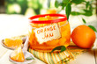 Orange jam with zest and tangerines, on white wooden table