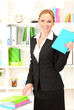 Photo: Portrait of teacher woman with book in classroom Portrait of teacher woman with book in classroom