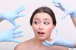 Rubber gloves touching face of young woman close up