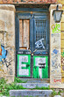 Weathered door and heavy graffiti on a abandoned house in Athens