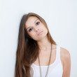 young female leaning against the wall