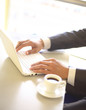 Closeup of businessman typing on laptop computer