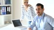 Business people working in office on laptop