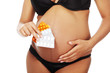 Photo: Young beautiful pregnant woman holding pills Young beautiful pregnant woman holding pills