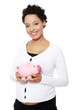 Photo: Pregnant woman holding piggy bank Pregnant woman holding piggy bank