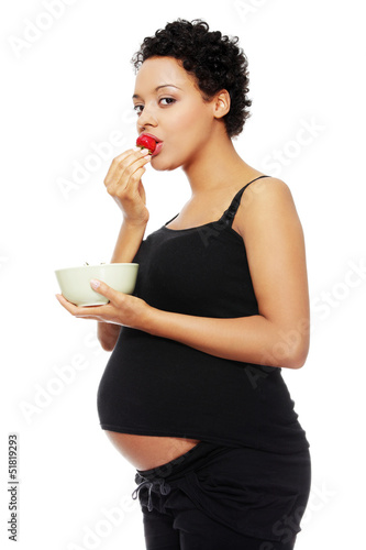 Photo: Young happy pregnant woman with strawberries Young happy pregnant woman with strawberries