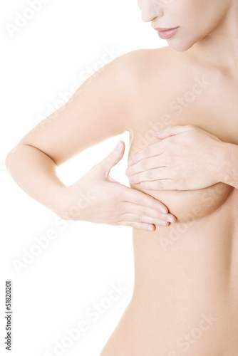 Photo: Caucasian adult woman examining her breast Caucasian adult woman examining her breast