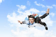 Young businessman flying with parachute on back