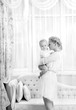 Foto: young mother with a baby in a beautiful bedroom young mother with a baby in a beautiful bedroom