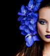 Fashionable beautiful woman with orchid in her hair