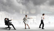Three business people pulling rope
