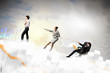 Three business people pulling rope