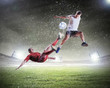 Photo: two football players striking the ball two football players striking the ball