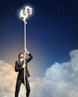 Image of businessman climbing rope