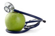 Stethoscope and green apple isolated on white background