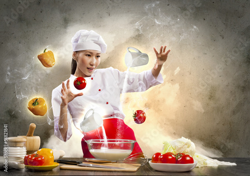 Photo: Asian female cooking with magic Asian female cooking with magic