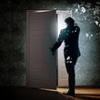 Young businessman opening door