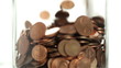 Eurocents falling in a glass
