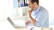 Happy businessman in front of laptop