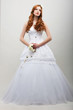 Sensuality. Fiancee in White Long Dress with Bouquet of Flowers