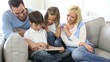 Family relaxing with kids and using digital tablet