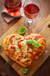 Heart shaped pizza with red wine