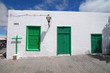 Old Church with green doors on a white wall