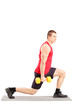 Full length portrait of a young man exercising with weights