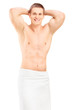 Handsome young man in towel posing