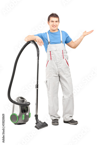 Photo: Full length portrait of a cleaning service employee posing with Full length portrait of a cleaning service employee posing with