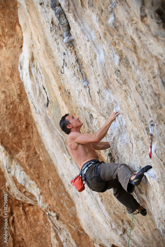 Photo: Rock climber on a face of a cliff Rock climber on a face of a cliff