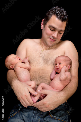 Photo: Young father with twins Young father with twins