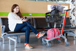 Woman looking at tablet pc in airport waiting room