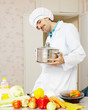 male cook in uniform with pan