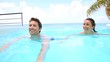 Couple swimming in infinity pool