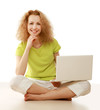 Photo: A young girl sitting on the floor with a laptop A young girl sitting on the floor with a laptop