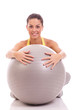 young, beautiful woman hugging big gray ball