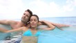 Couple relaxing in swimming-pool