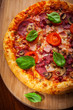 Foto: Traditional pizza with salami and mushrooms Traditional pizza with salami and mushrooms