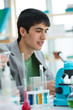 High School students. Handsome mixed race guy working at laborat