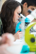 High School students. Young pretty girl student peering through