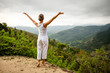 Photo: Woman is doing yoga exercises in mountains Woman is doing yoga exercises in mountains